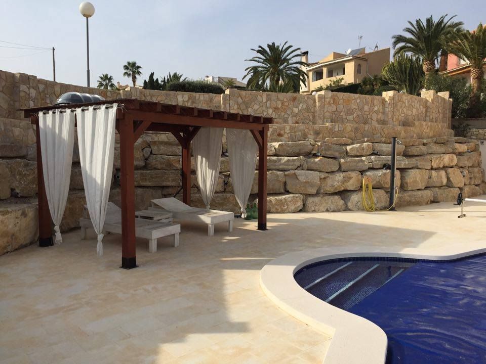Muro de escollera terminado junto a una piscina en Coveta Fumá